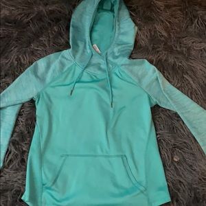 A teal hoodie that is fuzzy on the inside.
